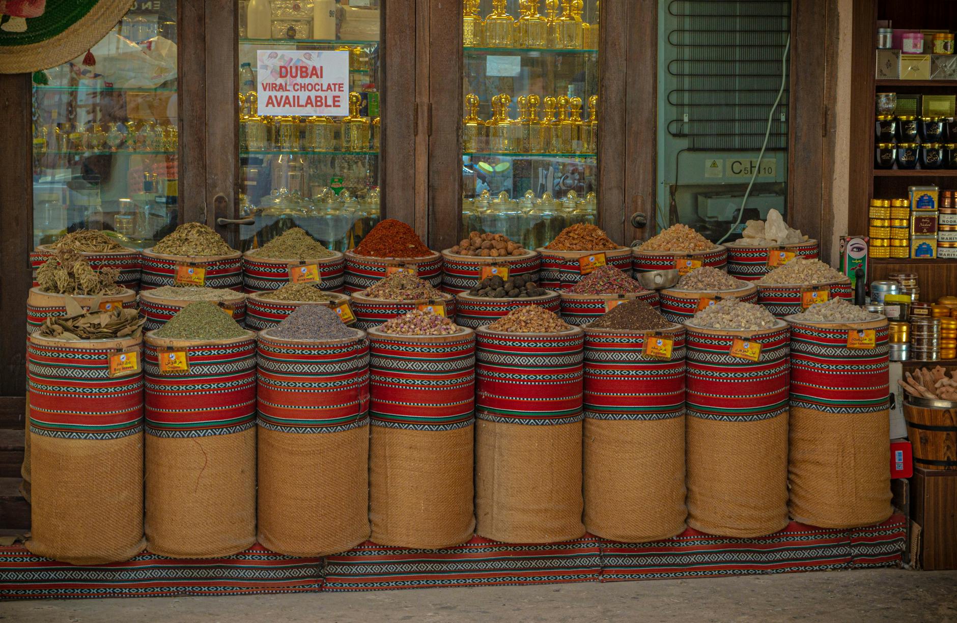 Colorful display of spices in Dubai's souk showcasing traditional Middle Eastern flavors and aromas.